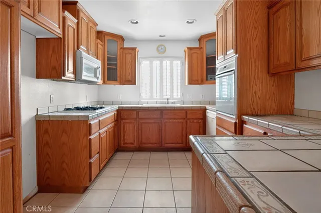 a white stove top oven sitting inside of a kitchen