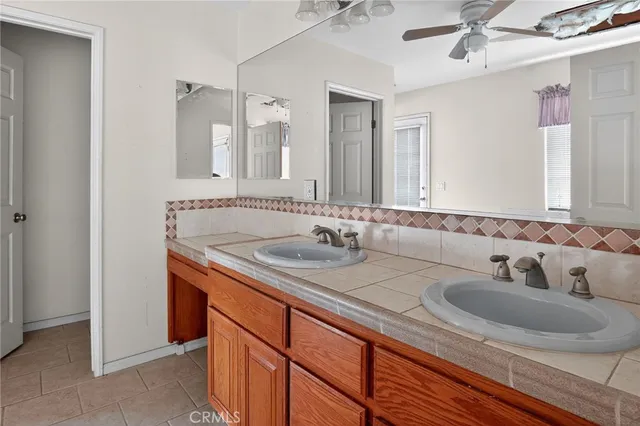 a spacious bathroom with a tub sink and mirror
