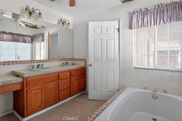 a bathroom with a granite countertop sink a toilet and bathtub