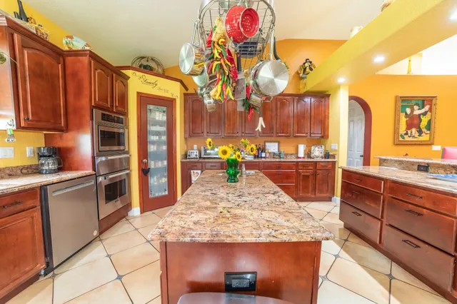 a dining room with furniture a chandelier and a rug