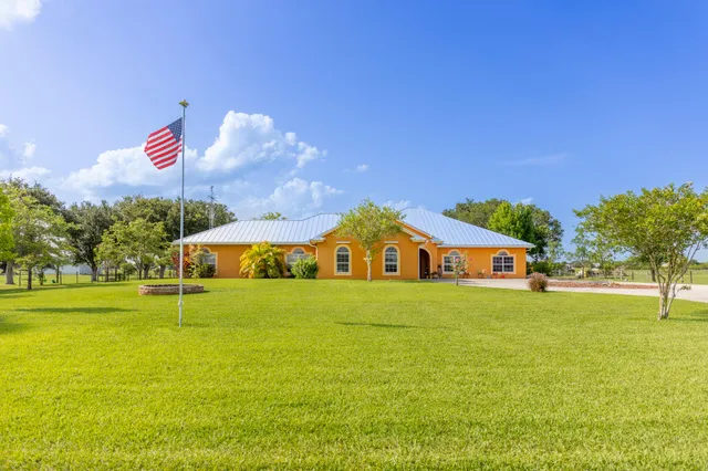 a aerial view of a house with a yard