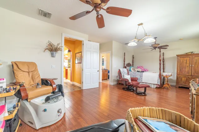 a living room with furniture and a wooden floor