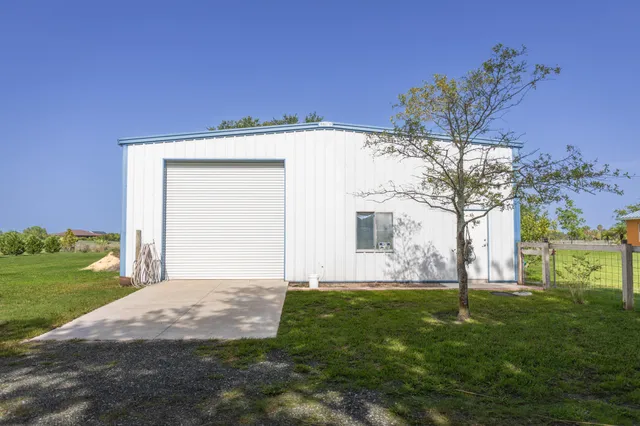 a view of a storage & utility room with fridge and closet
