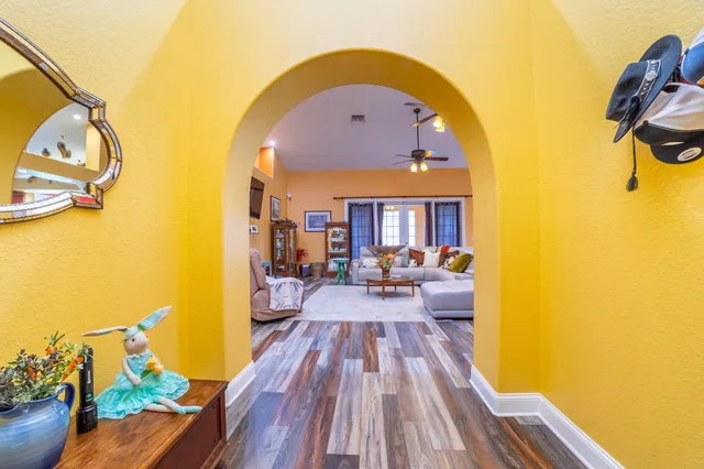 a kitchen with stainless steel appliances kitchen island granite countertop a table chairs and a refrigerator