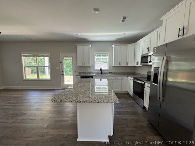 390 Summerhill Road Fayetteville, NC 28303 - Photo 27 of 27 a kitchen with kitchen island granite countertop a stove a sink and a refrigerator