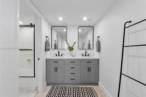 a spacious bathroom with a shower a sink and a mirror