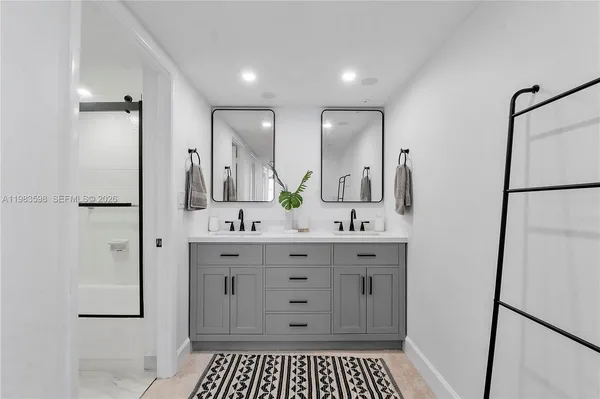 a spacious bathroom with a shower a sink and a mirror