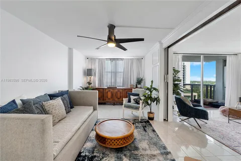 a living room with furniture a ceiling fan and a rug