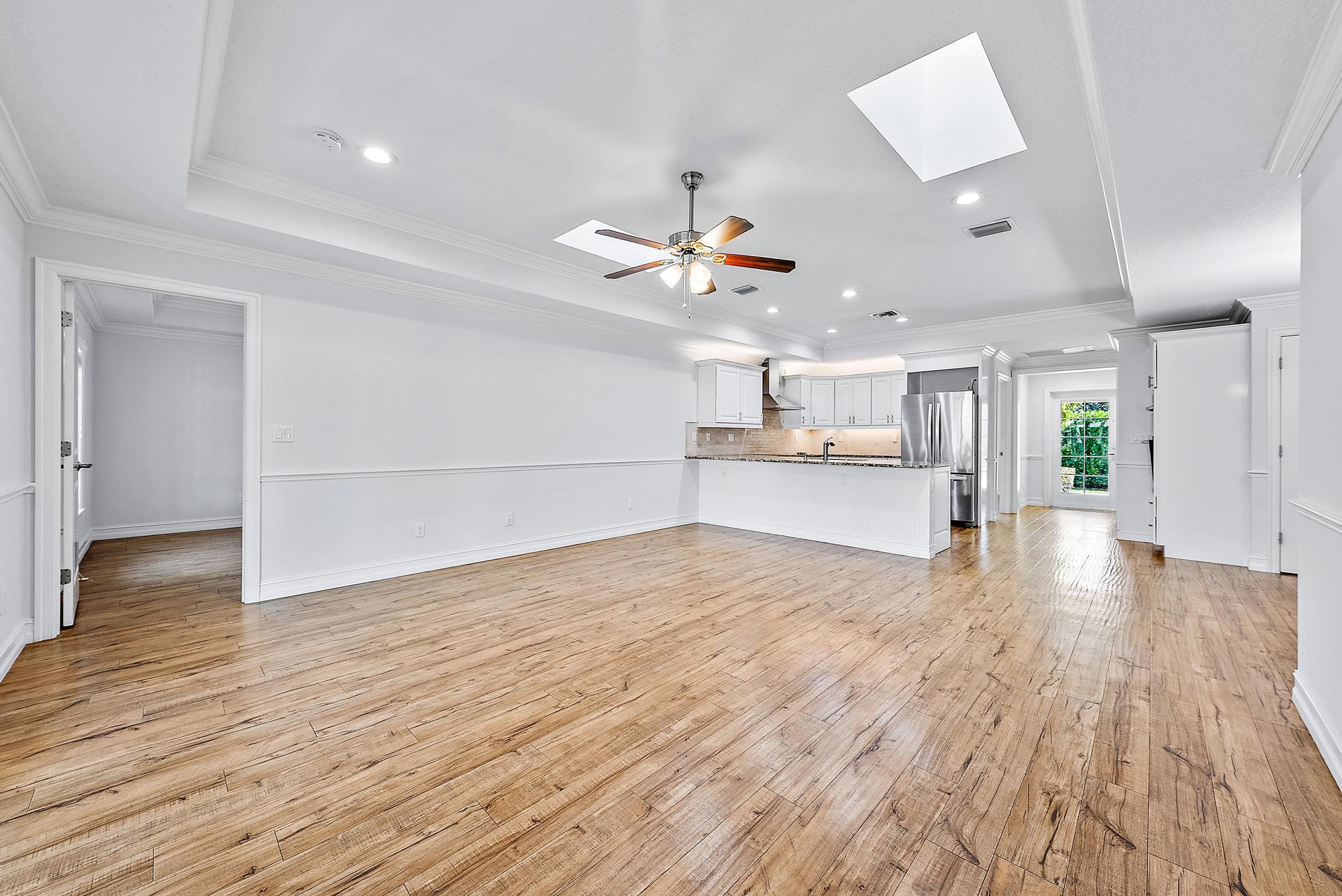 5791 Roebuck Road Jupiter, FL 33458 - Photo 9 of 23 a view of an empty room and wooden floor
