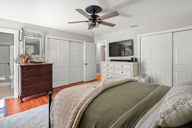 a bedroom with a bed and a chandelier