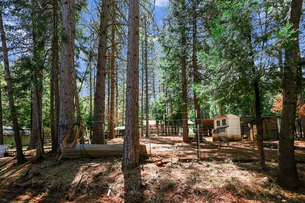 a view of a chairs and tables in the back yard of the house