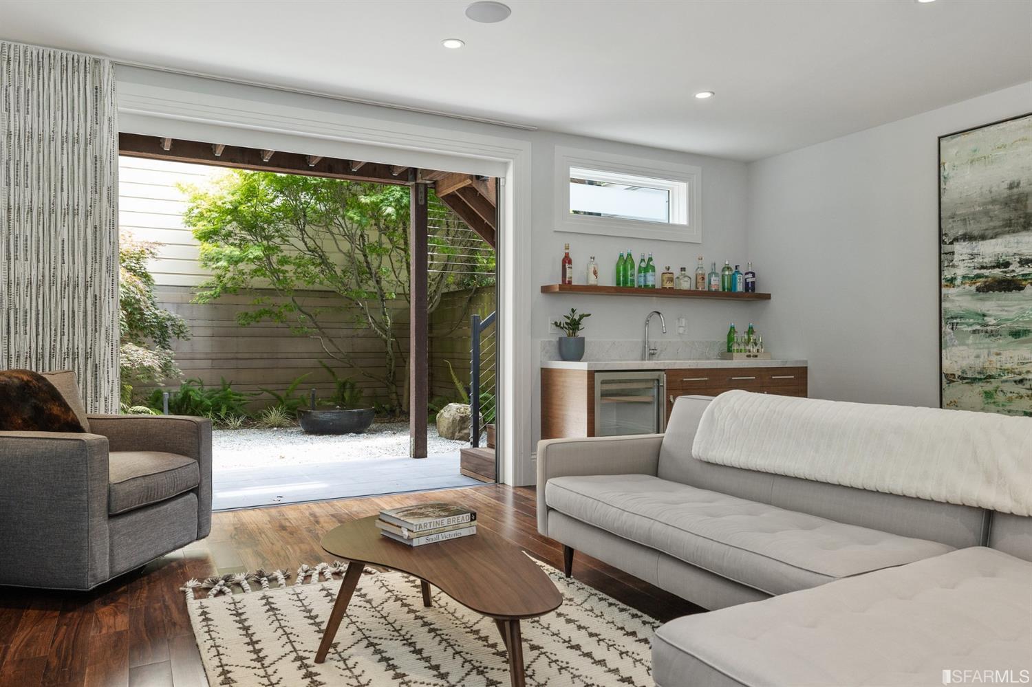 Clay Street San Francisco, CA 94115 - Photo 74 of 90 Lower level family room has a pet door, a built-in bar and lots of light with strategically placed windows and doors.