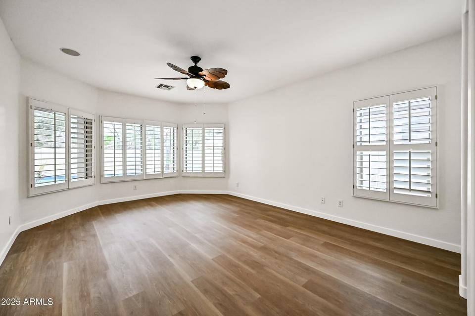 865 South Oak Street Gilbert, AZ 85233 - Photo 13 of 27 a view of an empty room with wooden floor and a window