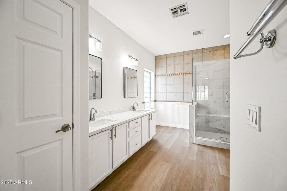 865 South Oak Street Gilbert, AZ 85233 - Photo 15 of 27 a bathroom with a double vanity sink and mirror with shower