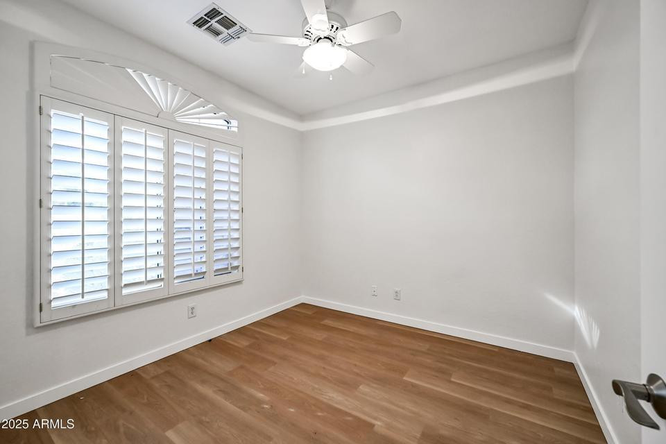 865 South Oak Street Gilbert, AZ 85233 - Photo 22 of 27 a view of empty room with wooden floor and fan