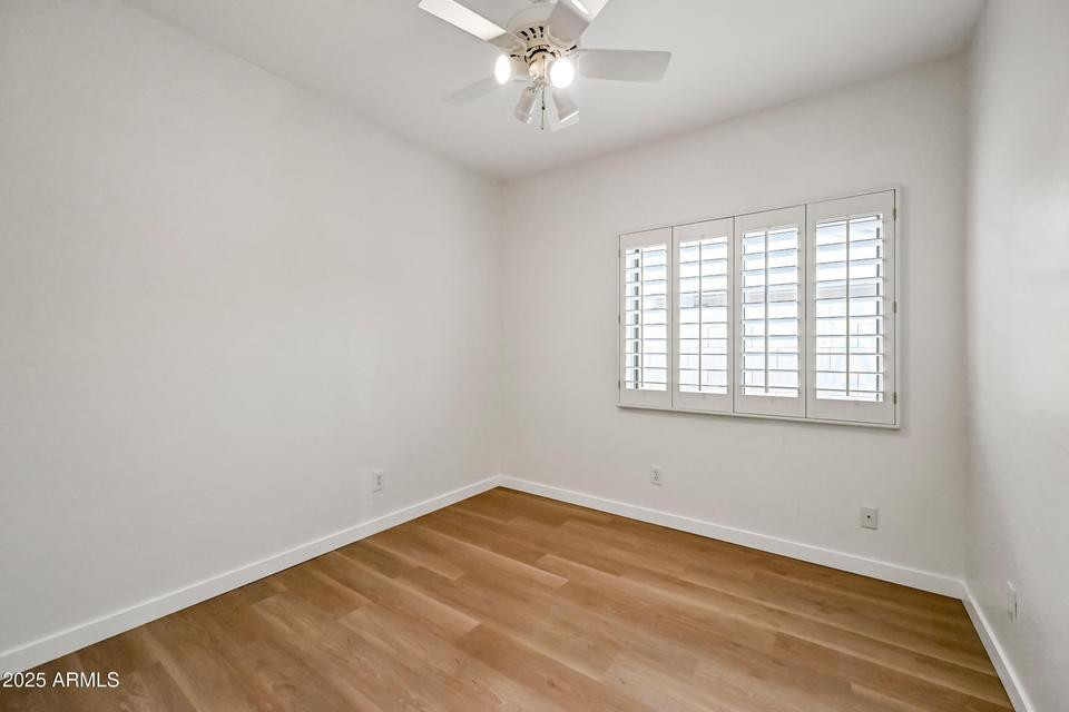 865 South Oak Street Gilbert, AZ 85233 - Photo 23 of 27 an empty room with a window and a ceiling fan