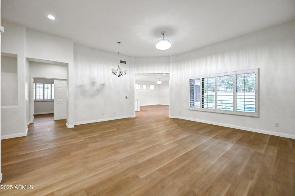 865 South Oak Street Gilbert, AZ 85233 - Photo 4 of 27 an empty room with wooden floor and windows