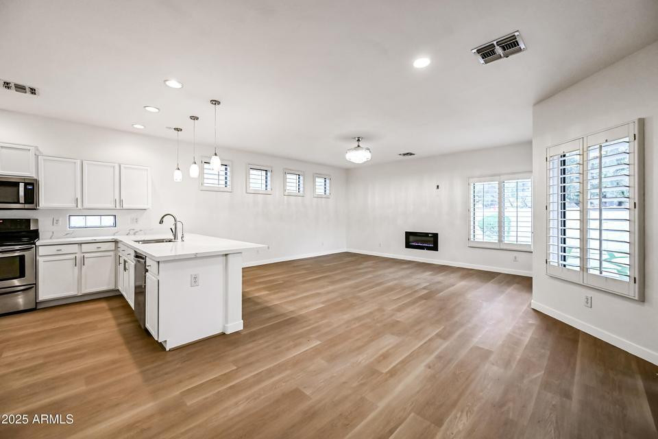 865 South Oak Street Gilbert, AZ 85233 - Photo 5 of 27 a kitchen with stove and cabinets
