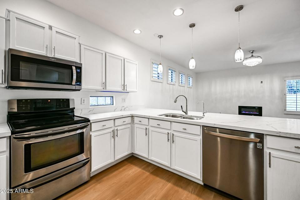 865 South Oak Street Gilbert, AZ 85233 - Photo 10 of 27 a kitchen with a sink stove and microwave