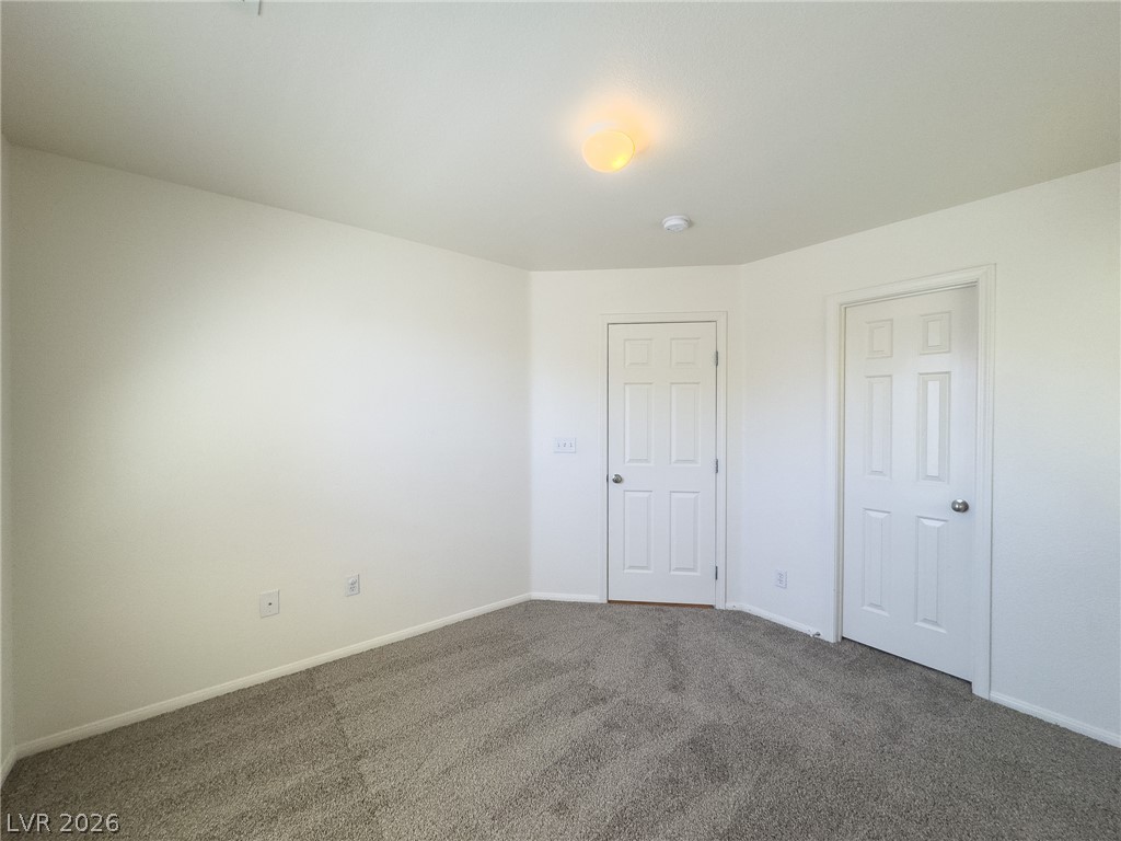 9456 Grandview Spring Avenue Las Vegas, NV 89166 - Photo 30 of 49 A well-proportioned bedroom with soft carpet and a simple overhead light offers a blank canvas for personalization.
