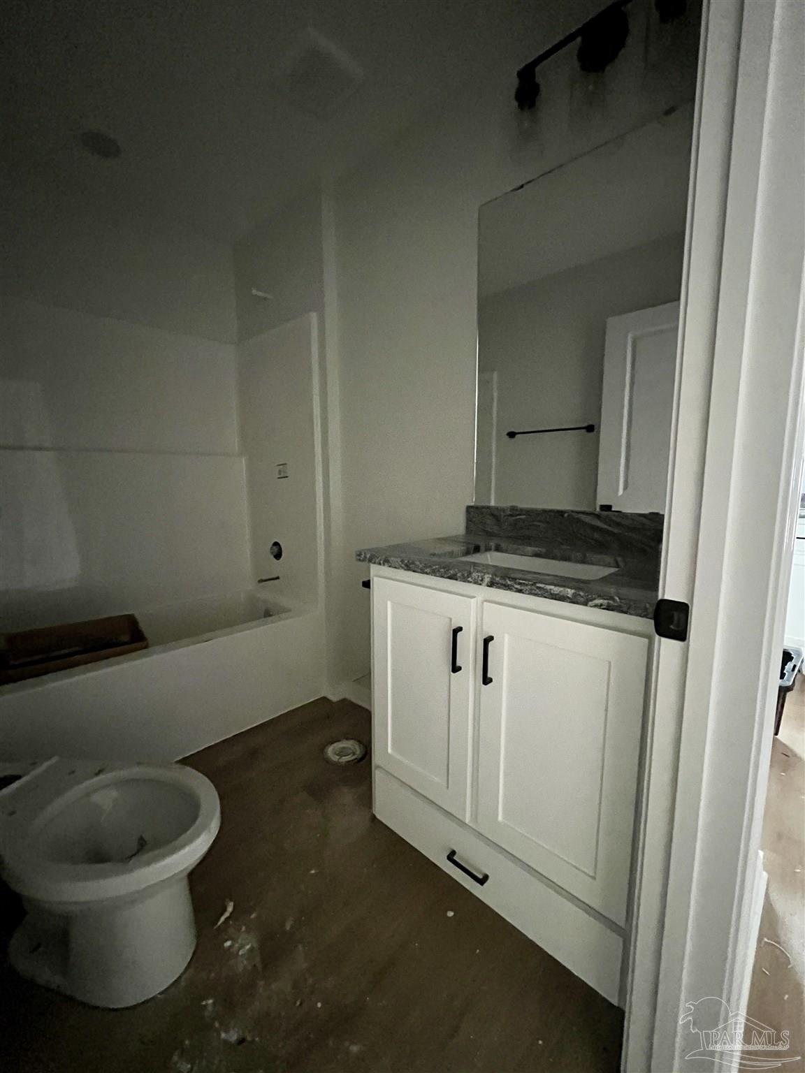 5634 Alabama Street Milton, FL 32570 - Photo 9 of 9 a bathroom with a granite countertop toilet and sink