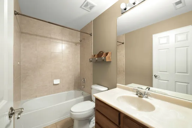 a bathroom with a sink toilet tub and shower