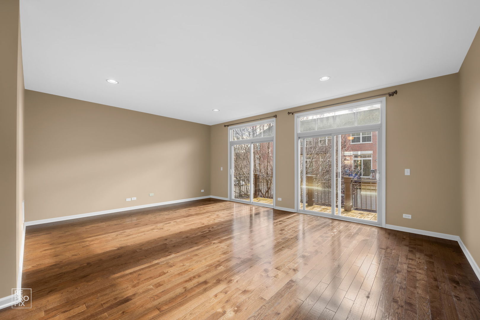 259 Aspen Pointe Road, Unit B Vernon Hills, IL 60061 - Photo 3 of 13 a view of an empty room with wooden floor and a window