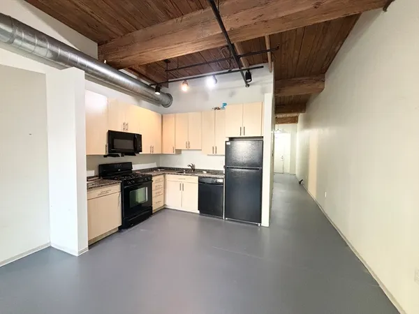 a kitchen with refrigerator and microwave