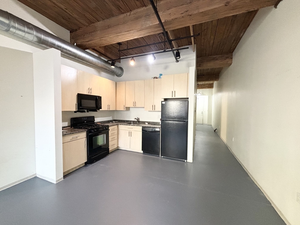 a kitchen with refrigerator and microwave