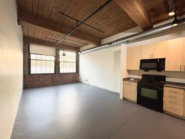 a kitchen with stove and cabinets