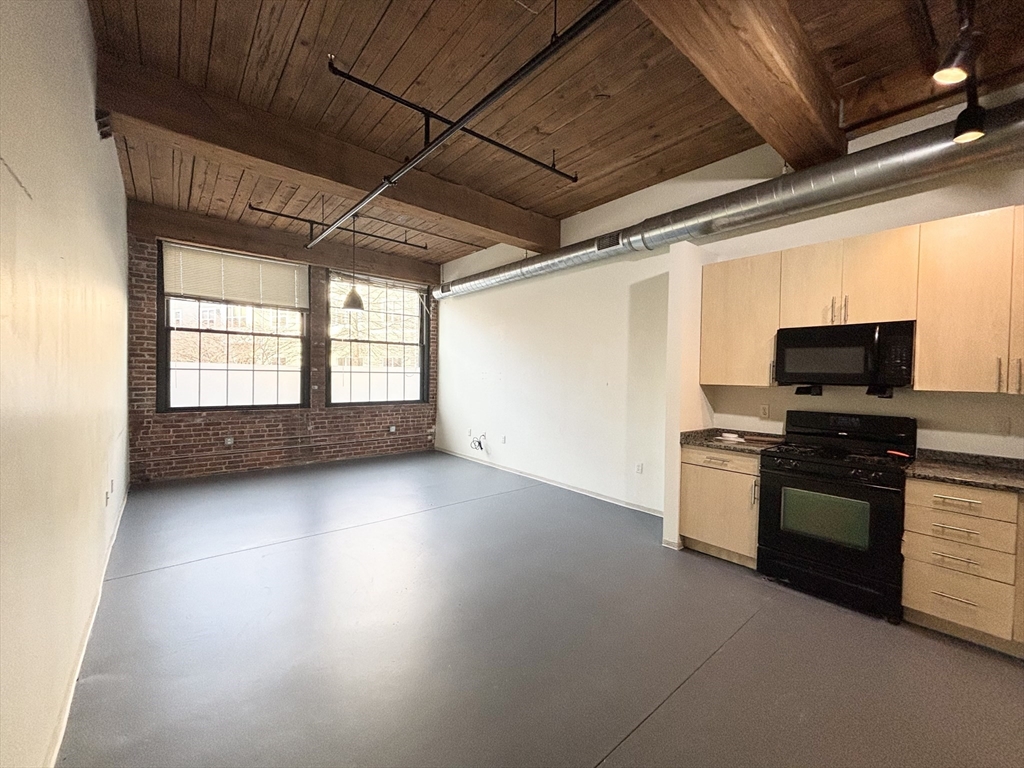 88 Gerrish Avenue, Unit 112 Chelsea, MA 02150 - Photo 2 of 16 a kitchen with stove and cabinets