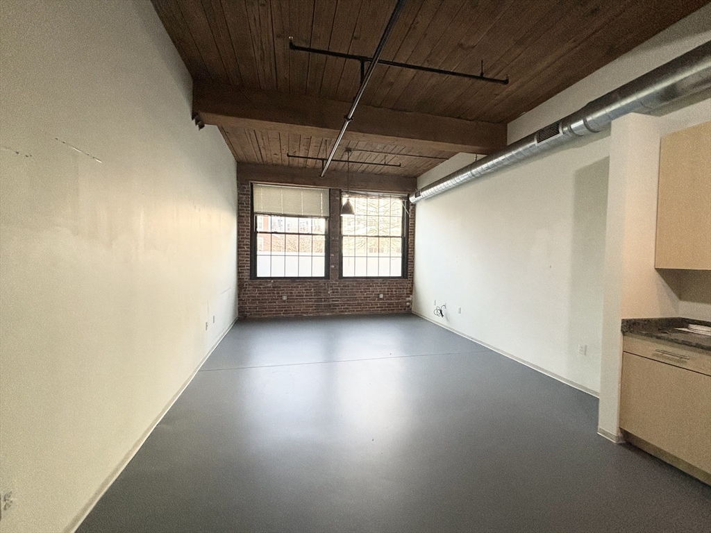 88 Gerrish Avenue, Unit 112 Chelsea, MA 02150 - Photo 3 of 16 a view of empty room with wooden floor and fan