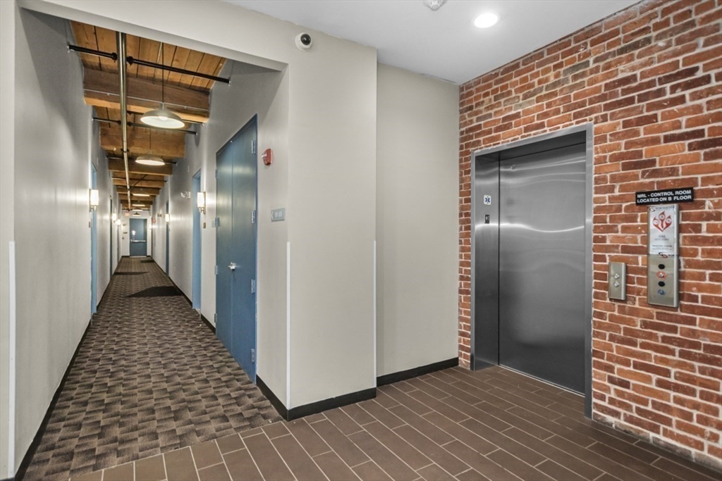 88 Gerrish Avenue, Unit 112 Chelsea, MA 02150 - Photo 8 of 16 a view of a hallway with wooden floor and staircase