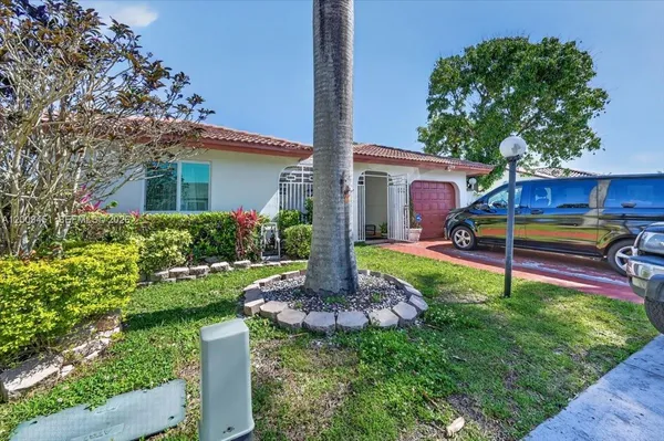 a front view of house with yard and green space