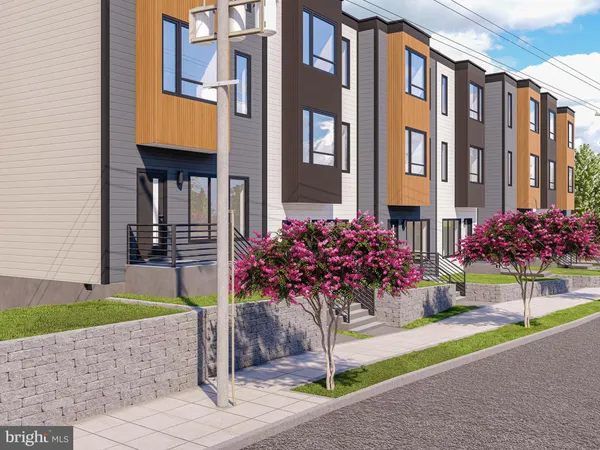 a front view of a multi story residential apartment building with a yard