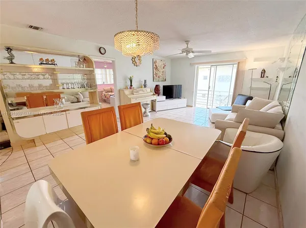 a view of a dining room with furniture and a chandelier