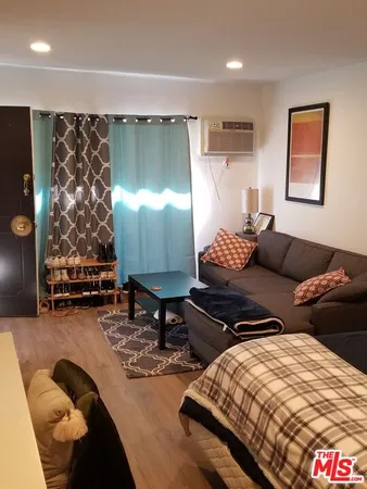 a room with a flat screen tv and a couch