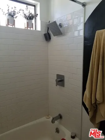 a bathroom with a bathtub and a toilet