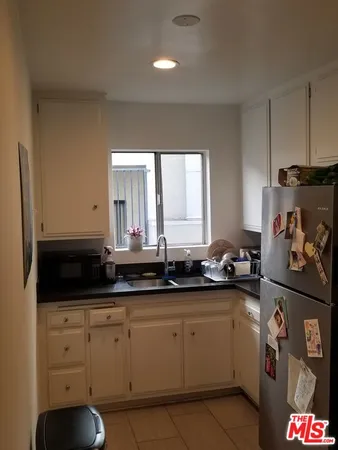 a kitchen with stainless steel appliances granite countertop a stove and a microwave