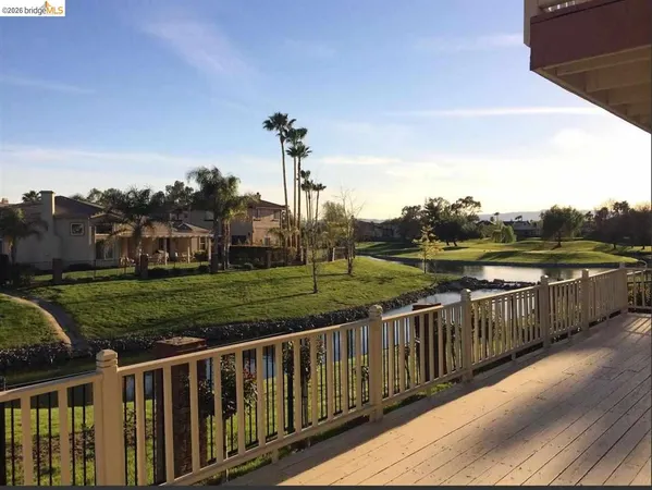 a view of a deck and yard with green space