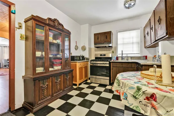 a kitchen with stainless steel appliances granite countertop a sink and a stove top oven