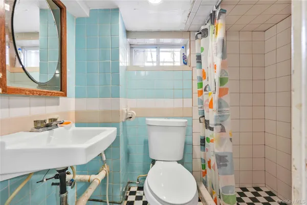 a bathroom with a sink toilet a mirror and tub