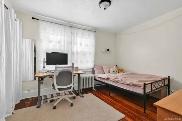 a bedroom that has a bed and a chair in it