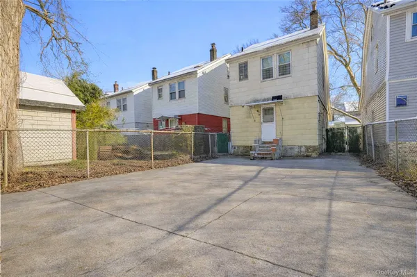 a view of a house with a wooden bench