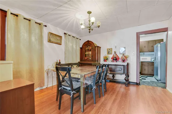 a view of a dining room with furniture wooden floor and a chandelier