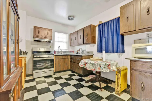 a kitchen with a checkered floor and white appliances