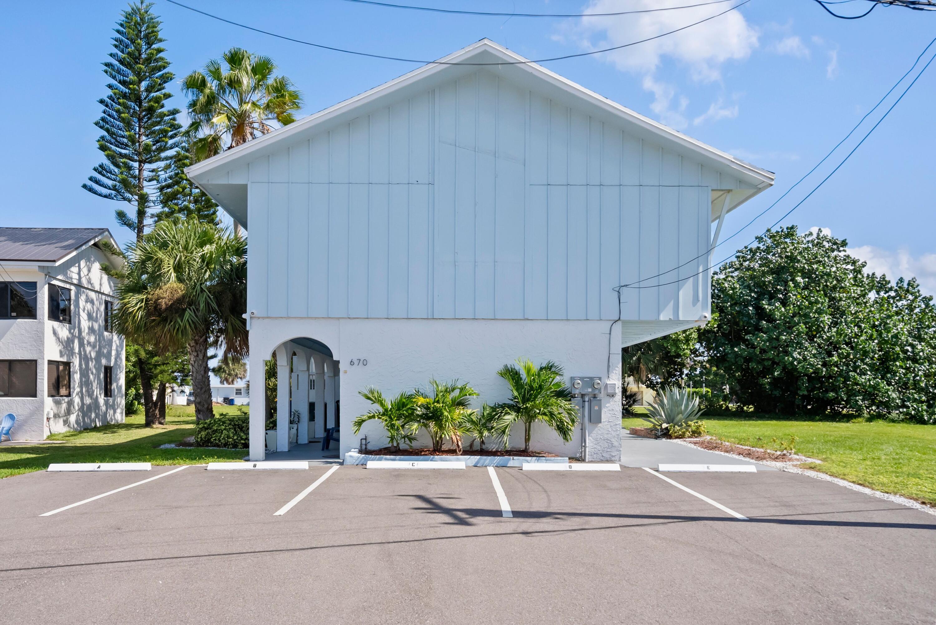 670 Hernando Street, Unit A Fort Pierce, FL 34949 - Photo 15 of 21 a couple of cars parked in front of a house