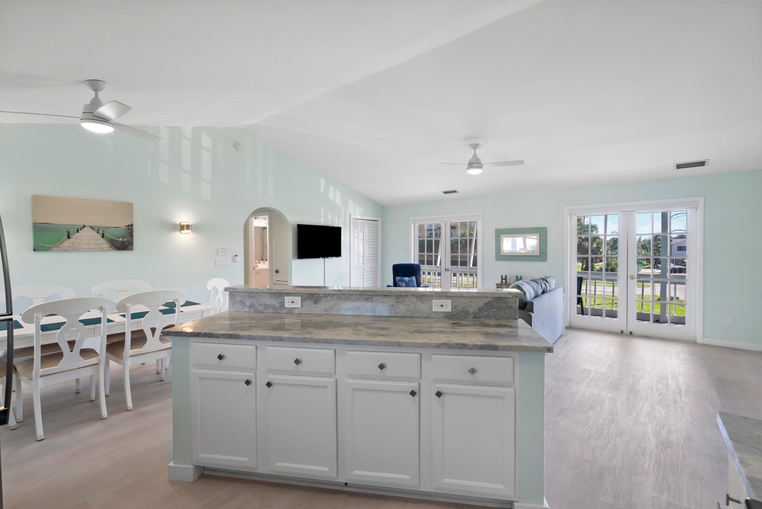 670 Hernando Street, Unit A Fort Pierce, FL 34949 - Photo 3 of 21 a kitchen with center island table and chairs