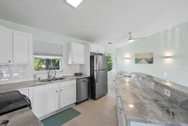 a kitchen with a sink appliances and cabinets