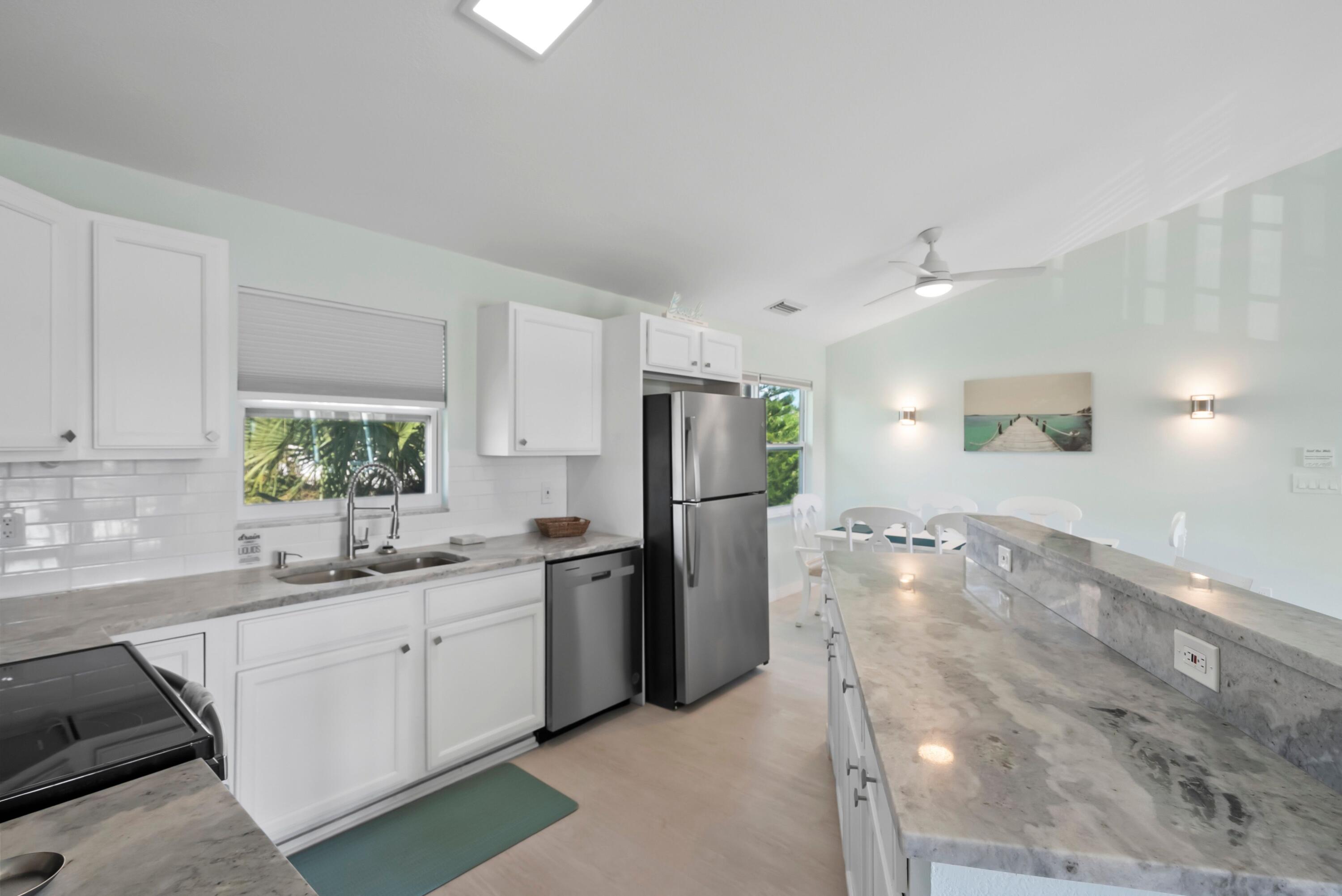 670 Hernando Street, Unit A Fort Pierce, FL 34949 - Photo 4 of 21 a kitchen with a sink appliances and cabinets